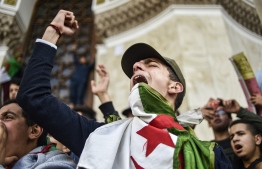 Algerian students shout slogans as they demonstrate with national flags outside La Grande Poste (main post office) in the centre of the capital Algiers on March 10, 2019 against ailing Algerian President Abdelaziz Bouteflika's bid for a fifth term. PHOTO: RYAD KRAMDI / AFP
