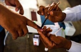 An Indian voter gets her finger marked with ink at a polling station during India's general election in Shahpur near Muzaffarrnagar in the northern Indian state of Uttar Pradesh on April 11, 2019. - India's mammoth six-week general election kicked off April 11, with polling stations in the country's northeast among the first to open. (Photo by Money SHARMA / AFP)