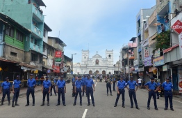 Sri Lankan security personnel keep watch outside the church premises following a blast at the St. Anthony's Shrine in Kochchikade, Colombo on April 21, 2019. - Explosions have hit three churches and three hotels in and around the Sri Lankan capital of Colombo, police said on April 21. (Photo by ISHARA S.  KODIKARA / AFP)