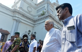 Sri Lankan Prime Minister Ranil Wickremasinghe (2nd R) arrives to visit the site of a bomb attack at St. Anthony's Shrine in Kochchikade in Colombo on April 21, 2019. - A string of blasts ripped through high-end hotels and churches holding Easter services in Sri Lanka on April 21, killing at least 156 people, including 35 foreigners. (Photo by ISHARA S. KODIKARA / AFP)