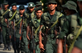 Military personnel keep watch outside the St Sebastian's Church in Negombo on April 23, 2019, two days after a series of bomb blasts targeting churches and luxury hotels in Sri Lanka. - Sri Lankans across the island nation observed three minutes of silence early April 23 to pay tribute to nearly 300 people killed in a string of suicide attacks. (Photo by ISHARA S. KODIKARA / AFP)