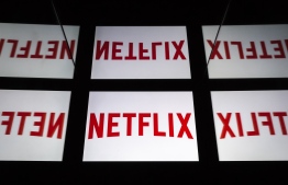 (FILES) In this file photo taken on February 18, 2019 This illustration picture shows the US Online Streaming giant Netflix logo displayed on a tablet in Paris. PHOTO: LIONEL BONAVENTURE / AFP