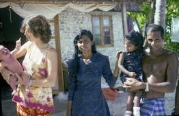 Frank's wife Gayle holding Dhon Kokko pictured with a family from the island. PHOTO: FRANK BURNABY