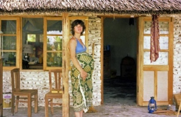 Gayle during her pregnancy in front of the house built for the family by people of Bodufolhudhoo. PHOTO: FRANK BURNABY