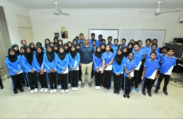 Mauroof Ahmed (Maattey) pictured with the students that participated in the first 'Champion's Talk' session. PHOTO: HUSSAIN WAHEED / MIHAARU