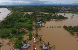 This aerial picture taken on April 27, 2019 shows a general view of submerged buildings after heavy rain caused flooding in Bengkulu on the Indonesian island of Sumatra. - At least 10 people are dead and eight are missing after days of heavy rain-triggered floods and landslides on the Indonesian island of Sumatra, authorities said on April 28. (Photo by DIVA MARHA / AFP)