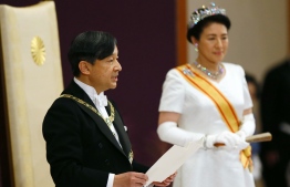 Japan’s new Emperor Naruhito (L) delivers his speech as new Empress Masako (R) stands next to him during a ceremony to receive the first audience after the accession to the throne at the Matsu-no-Ma state room inside the Imperial Palace in Tokyo on May 1, 2019. Japan's new Emperor Naruhito formally ascended the Chrysanthemum Throne on May 1, a day after his father abdicated from the world's oldest monarchy and ushered in a new imperial era. PHOTO/AFP