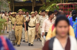 Indian Police personnel and other officials get ready ahead of elections slated to be held on April 29, at an election polling booth in Thane on April 28, 2019. (Photo by STR / AFP)