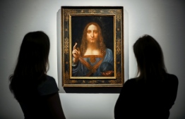 (FILES) In this file photo taken on October 24, 2017 Christie's employees pose in front of a painting entitled Salvator Mundi by Italian polymath Leonardo da Vinci at a photocall at Christie's auction house in central London ahead of its sale at Christie's New York on November 15, 2017. - Later this year, the Louvre museum in Paris will host an exhibition grouping masterpieces of the great Italian painter Leonardo da Vinci to mark his death 500 years ago in France.
The "Salvator Mundi", sold at auction as a work by Leonardo for a record $450 million dollars in 2017, has not been displayed in public since, as doubts swirl about its ownership, whereabouts and authenticity. (Photo by Tolga Akmen / AFP) / RESTRICTED TO EDITORIAL USE - MANDATORY MENTION OF THE ARTIST UPON PUBLICATION - TO ILLUSTRATE THE EVENT AS SPECIFIED IN THE CAPTION