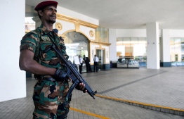 In this picture taken on May 1, 2019, a Sri Lankan soldier stands guard at the entrance of the Cinnamon Grand hotel lobby in Colombo. - On April 21, the Cinnamon was one of three hotels hit by jihadi bombers along with three churches in attacks claimed by the Islamic State group that left 257 people dead. (Photo by ISHARA S.  KODIKARA / AFP) / 
