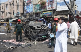 Pakistani security officials examine the site of a bomb blast outside a Sufi shrine in Lahore on May 8, 2019. - A blast at one of Pakistan's oldest and most popular Sufi shrines killed at least five people and wounded 24 in the eastern city of Lahore May 8, police said, as the country marks the fasting month of Ramadan. (Photo by ARIF ALI / AFP)