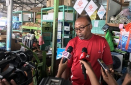 The stalls owner Abdulla speaking to the press. PHOTO: MIHAARU