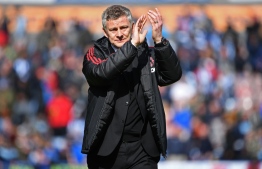 Manchester United's Norwegian manager Ole Gunnar Solskjaer applauds supporters after the English Premier League football match between Huddersfield Town and Manchester United at the John Smith's stadium in Huddersfield, northern England on May 5, 2019. - Manchester United fail to qualify for the Champions League after 1-1 draw at Huddersfield. (Photo by Paul ELLIS / AFP) / RESTRICTED TO EDITORIAL USE. No use with unauthorized audio, video, data, fixture lists, club/league logos or 'live' services. Online in-match use limited to 120 images. An additional 40 images may be used in extra time. No video emulation. Social media in-match use limited to 120 images. An additional 40 images may be used in extra time. No use in betting publications, games or single club/league/player publications. / 