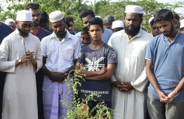 Relatives mourn beside the coffin of Fauzul Ameen, the victim of an anti-Muslim riots, during a burial ceremony in a Muslim cemetery in Nattandiya on May 14, 2019. - Sri Lanka's police declared on May 14 a nationwide curfew for a second night running, after anti-Muslim riots killed one man and left dozens of shops, homes and mosques damaged. PHOTO: LAKRUWAN WANNIARACHCHI / AFP