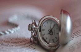A pocket watch rests on an open book. PHOTO/sternenfern