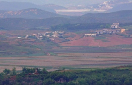 North Korea's border county of Kaepoong is seen from a South Korean observation post in Paju near the Demilitarized Zone (DMZ) dividing the two Koreas on May 17, 2019. - North Korea is experiencing its worst drought in over a century, official media reported on May 17, days after the World Food Programme expressed "serious concerns" about the situation in the country. (Photo by Jung Yeon-je / AFP)
