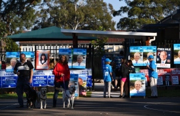 Resident arrive to cast their votes at the Lilly Pilly polling booth during the Australia's general election in Sydney on May 18, 2019. (Photo by Saeed KHAN / AFP)