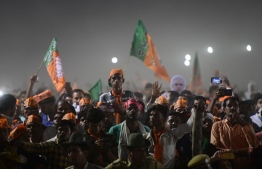 Bharatiya Janata Party (BJP) supporters attend a rally as Indian Prime Minister Narendra Modi  delivers a speech during a rally ahead of Phase VI of India's general election in Allahabad on May 9, 2019. (Photo by SANJAY KANOJIA / AFP)