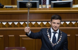 This picture taken and released by presidential press-service on May 20, 2019 shows Ukraine's President Volodymyr Zelensky holding the Bulava, the Ukrainian symbol of power, during his inauguration ceremony at the parliament in Kiev. (Photo by Markiv Mykhailo / UKRAINIAN PRESIDENTIAL PRESS SERVICE / AFP) / 