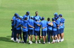 (FILES) In this file photo taken on March 01, 2019 Indian cricket team captain Virat Kohli (C) talks to his team members during a practice session ahead of the first one day international (ODI) cricket match between India and Australia at the Rajiv Gandhi International Cricket Stadium in Hyderabad on March 1, 2019. - India boast the game's undoubted superstar batsman in Virat Kohli but their bowling attack could hold the key to their hopes of World Cup glory. Despite their status as the game's global powerhouse, India have only won the showpiece tournament twice, in 1983 and 2011. (Photo by NOAH SEELAM / AFP) / ----IMAGE RESTRICTED TO EDITORIAL USE - STRICTLY NO COMMERCIAL USE----- / GETTYOUT