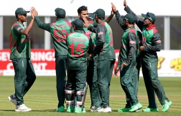 (FILES) In this file photo taken on May 13, 2019 Bangladesh's captain Mashrafe Mortaza (C) celebrates with teammates after taking the wicket of West Indies' Sunil Ambris (not pictured) during the Tri-Nation Series, one day international between Bangladesh and West Indies  Malahide cricket club, in Dublin on May 13, 2019. - Bangladesh have set their sights on capping a remarkable rise by reaching the World Cup semi-finals for the first time. Mashrafe Mortaza's team arrive in England confident of making the last four on the back of impressive form that marks them as a serious threat to the established order. (Photo by Paul Faith / AFP)