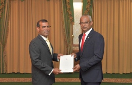 President Ibrahim Mohamed Solih presents Parliament speaker Mohamed Nasheed with the appointment letter for the-Judicial Service Commission. (JSC). PHOTO: PRESIDENT'S OFFICE