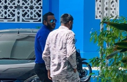 Former Vice President Ahmed Adeeb (L) escorted to the Criminal Court by an officer of Maldives Correctional Service. 