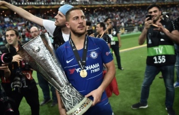 Chelsea's Belgian midfielder Eden Hazard holds the trophy after winning the UEFA Europa League final football match between Chelsea FC and Arsenal FC at the Baku Olympic Stadium in Baku, Azerbaijian, on May 29, 2019. (Photo by OZAN KOSE / AFP)