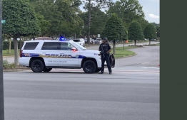 In this image recieved from Lucretia Cunningham via @SouthsideDaily to AFP, a police officer blocks a road to the Virginia Beach municipal complex, the site of a mass shooting, in Virginia Beach, Virginia on May 31, 2019. - A gunman went on a shooting spree at a government building complex in Virginia Beach, Virginia, killing 11 people and wounding six, police said. The gunman, a longtime public utilities employee, was also killed after trading fire with responding officers, police chief James Cervera told a news conference. (Photo by Lucretia Cunningham / @SouthsideDaily / AFP) / RESTRICTED TO EDITORIAL USE - MANDATORY CREDIT "AFP PHOTO / @SouthsideDaily/ Lucretia Cunningham" - NO MARKETING NO ADVERTISING CAMPAIGNS - DISTRIBUTED AS A SERVICE TO CLIENTS