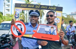 Head of Tourist Police (L) and Minister of Youth, Sports and Community Empowernment Ahmed Mahloof during a road safety awareness campaign. PHOTO: NISHAN ALI / MIHAARU