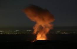 A fire rages and smoke billows following reported Syrian government forces' bombardment on the town of Khan Sheikhun in the southern countryside of Syria's Idlib province overnight on June 2, 2019. - A spike in violence in and around a jihadist bastion in northwest Syria has killed 948 people in a month, almost a third of them civilians, a war monitor said this week. (Photo by Anas AL-DYAB / AFP)
