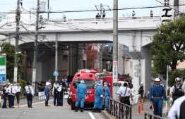 A gerenal view shows multiple police cars, ambulances and fire engines at a crime scene where a man stabbed 19 people, including children in Kawasaki on May 28, 2019. - Two people, including a child, were feared dead in a mass stabbing attack that also injured 17 people in the Japanese city of Kawasaki, the local fire department said. (Photo by Behrouz MEHRI / AFP)
