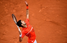 Serbia's Novak Djokovic serves the ball to Germany's Jan-Lennard Struff during their men's singles fourth round match on day nine of The Roland Garros 2019 French Open tennis tournament in Paris on June 3, 2019. (Photo by Martin BUREAU / AFP)