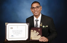 Chef Sobah posing for a picture with the President's Award. PHOTO: SOBAH
