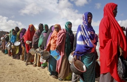 In this Saturday, May 18, 2019 file photo, newly-arrived women who fled drought line up to receive food distributed by local volunteers at a camp for displaced persons in the Daynile neighbourhood on the outskirts of the Somalian capital Mogadishu. PHOTO: AP / Farah Abdi Warsameh