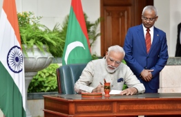 Prime Minister Narendra Modi signs the guest book at the President's Office, during his call on President Ibrahim Mohamed Solih on June 8, 2019. PHOTO: NISHAN ALI / MIHAARU 