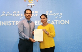 Former Education Minister Dr. Aishath Ali hands over the letter of appointment to Ahmed Ali, who had been appointed as Permanent Secretary of the Ministry of Education - Photo: Ministry of Education