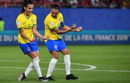 Brazil's forward Marta (R) celebrates with Brazil's midfielder Thaisa after scoring a goal during the France 2019 Women's World Cup Group C football match between Italy and Brazil, on June 18, 2019, at the Hainaut Stadium in Valenciennes, northern France. (Photo by Philippe HUGUEN / AFP)