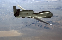 This undated US Air Force file photo released on June 20, 2019 shows a photo of a RQ-4 Global Hawk unmanned surveillance and reconnaissance aircraft. - A US spy drone was some 34 kilometers (21 miles) from the nearest point in Iran when it was shot down over the Strait of Hormuz by an Iranian surface-to-air missile June 20, 2019, a US general said. "This dangerous and escalatory attack was irresponsible and occurred in the vicinity of established air corridors between Dubai, UAE, and Oman, possibly endangering innocent civilians," said Lieutenant General Joseph Guastella, who commands US air forces in the region."At the time of the intercept the RQ-4 was at high altitude, approximately 34 kilometers from the nearest point of land on the Iranian coast," he said, over a video to the Pentagon press briefing room. (Photo by Handout / US AIR FORCE / AFP) / 