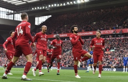 (FILES) A file photo taken on April 14, 2019 shows Liverpool's Egyptian midfielder Mohamed Salah (2nd-R) celebrating with teammates after scoring their second goal during the English Premier League football match between Liverpool and Chelsea at Anfield in Liverpool, north west England. - As a teenager, he spent ten hours travelling in Cairo to train for football. Today, at the age of 27, Mohamed Salah has won the Champions League and is one of the 100 most influential people in the world according to Time Magazine. (Photo by Paul ELLIS / AFP) / RESTRICTED TO EDITORIAL USE. No use with unauthorized audio, video, data, fixture lists, club/league logos or 'live' services. Online in-match use limited to 120 images. An additional 40 images may be used in extra time. No video emulation. Social media in-match use limited to 120 images. An additional 40 images may be used in extra time. No use in betting publications, games or single club/league/player publications. / 