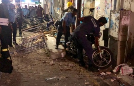 Maldives Police Service operating at the scene where part of a building fell. PHOTO: SOCIAL MEDIA