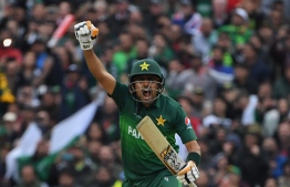 Pakistan's Babar Azam celebrates after scoring a century (100 runs) during the 2019 Cricket World Cup group stage match between New Zealand and Pakistan at Edgbaston in Birmingham, central England, on June 26, 2019. (Photo by Paul ELLIS / AFP) / 