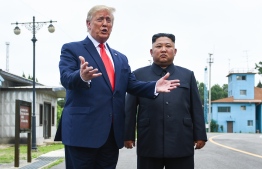 US President Donald Trump speaks as he stands with North Korea's leader Kim Jong Un south of the Military Demarcation Line that divides North and South Korea, in the Joint Security Area (JSA) of Panmunjom in the Demilitarized zone (DMZ) on June 30, 2019. (Photo by Brendan Smialowski / AFP)