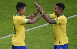 Brazil's Roberto Firmino (L) celebrates with Brazil's Gabriel Jesus after scoring against Argentina during their Copa America football tournament semi-final match at the Mineirao Stadium in Belo Horizonte, Brazil, on July 2, 2019. (Photo by MAURO PIMENTEL / AFP)