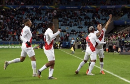 Peru's Yoshimar Yotun (R) celebrates with teammates after scoring against Chile during their Copa America football tournament semi-final match at the Gremio Arena in Porto Alegre, Brazil, on July 3, 2019. (Photo by Juan MABROMATA / AFP)