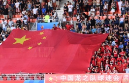 China's supporters deploy a giant Chinese flag ahead ofg the France 2019 Women's World Cup round of sixteen football match between Italy and China, on June 25, 2019, at La Mosson stadium in Montpellier, south western France. (Photo by Boris HORVAT / AFP)