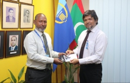 Commissioner General of Customs Ahmed Noomaan presents the letter of appointment and badge to the new Deputy Commissioners Abdulla Shareef. PHOTO: MALDIVES CUSTOMS