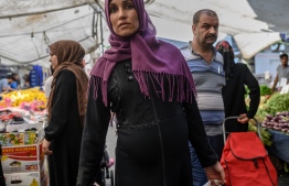 A Syrian woman walks in the bazaar in Istanbul's working-class district of Kucukcekmece on July 5, 2019. - The most recent violence against Syrians in Kucukcekmece 10 days ago has raised fears of an escalation in an already volatile climate. Xenophobic language has been unleashed, particularly during the campaigns for local elections. Turkey is home to the largest number of refugees in the world, having welcomed over 3.5 million Syrians -- including 500,000 in Istanbul -- who were forced to flee their country. (Photo by BULENT KILIC / AFP)