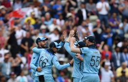 England's Adil Rashid celebrates with teammates the wicket of Australia's Alex Carey for 46 during the 2019 Cricket World Cup second semi-final between England and Australia at Edgbaston in Birmingham, central England,  on July 11, 2019. (Photo by Paul ELLIS / AFP) / 