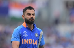 India's captain Virat Kohli leaves the pitch after losing his wicket for 1 run during the 2019 Cricket World Cup first semi-final between New Zealand and India at Old Trafford in Manchester, northwest England, on July 10, 2019. (Photo by Dibyangshu Sarkar / AFP) / 